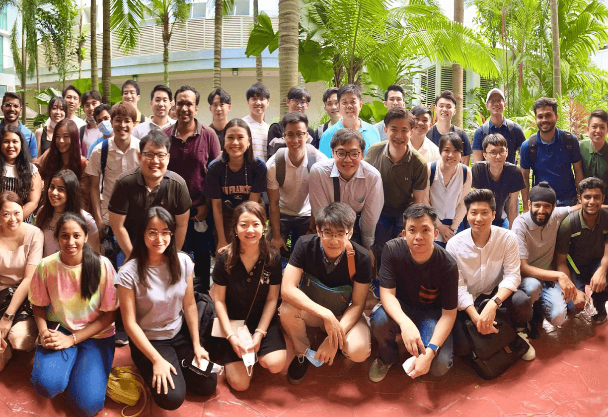 SimplifyNext team members posing for a group photo at a social event, standing in rows and smiling at the camera.